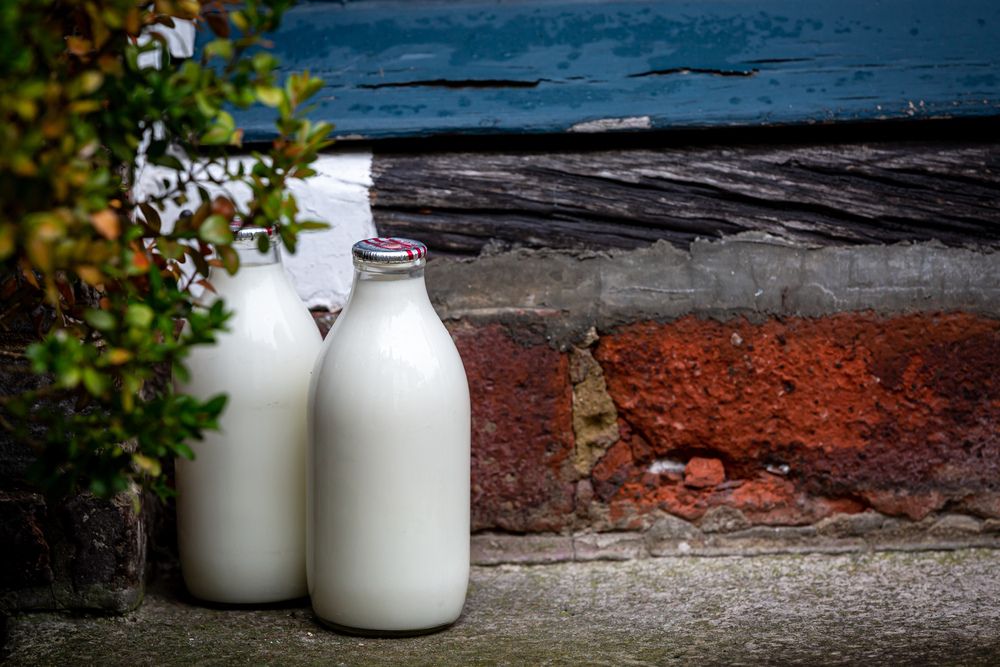 Red top milk bottles on a doorstep
